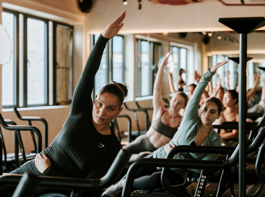 people in a class - Aerial Yoga Stretches