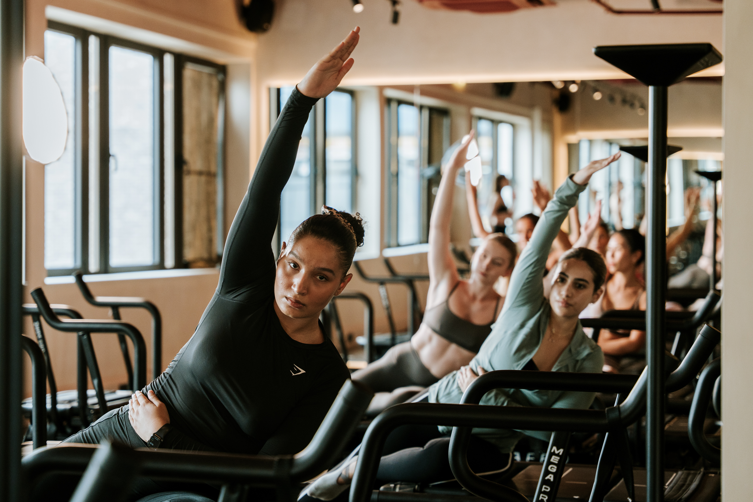 people in a class - Aerial Yoga Stretches